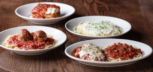 four plates of pasta on a table