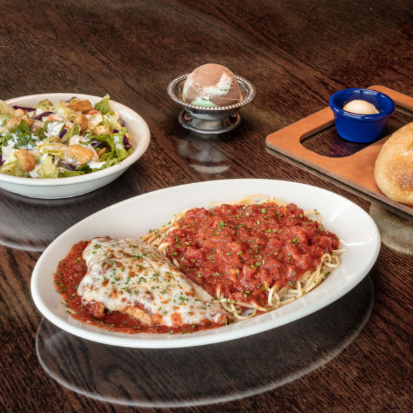 three course meal of pasta, salad, spumoni, and bread