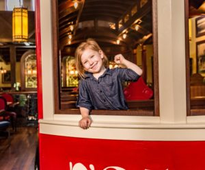 child in trolley smiling at The Old Spaghetti Factory